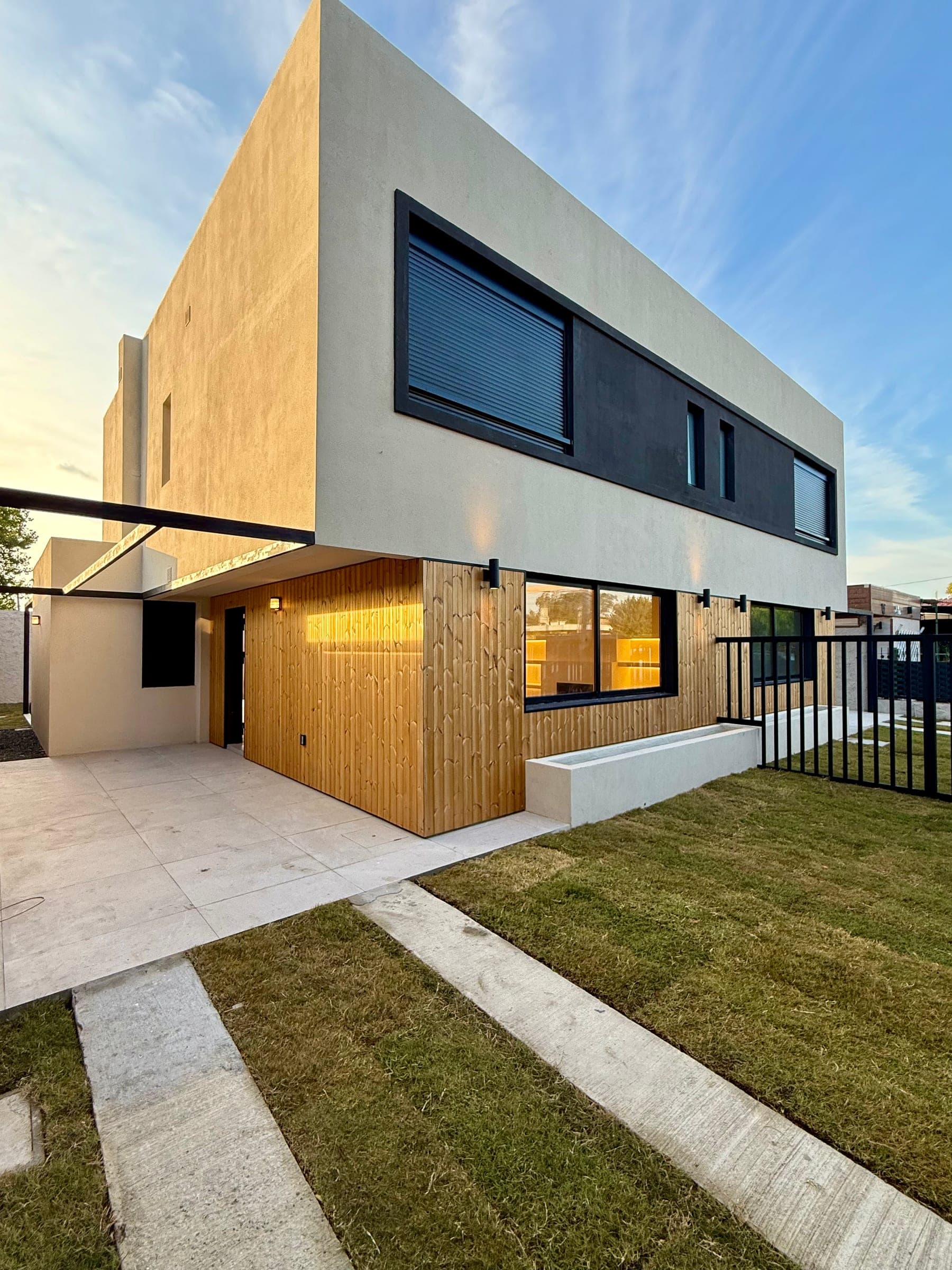 Façade of the duplex homes at Barra de Carrasco I, with wood cladding